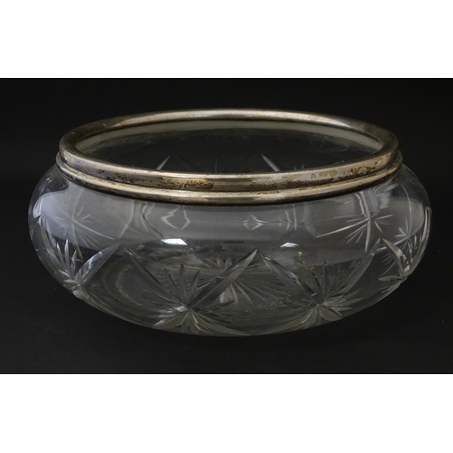 300 - A cut glass bowl with silver rim hallmarked London 1927. Approx 3 3/4