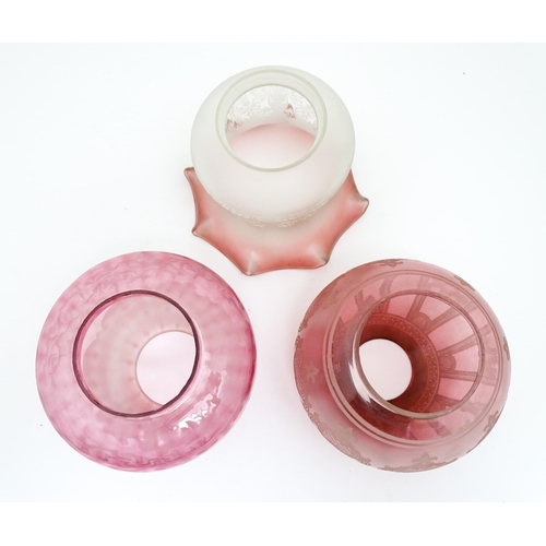 307 - Three various Victorian and later cranberry and pink glass lamp / light shades. The largest approx 6... 