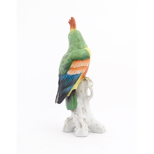 175 - A Capodimonte model of a Parrot with green, yellow, red and blue feathers perched on branch. Marked ... 