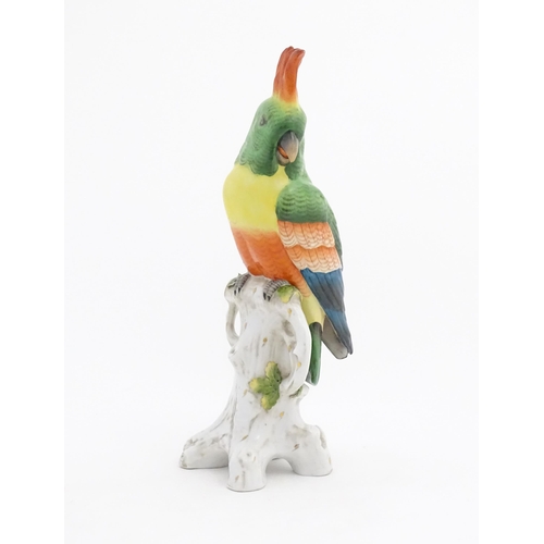 175 - A Capodimonte model of a Parrot with green, yellow, red and blue feathers perched on branch. Marked ... 