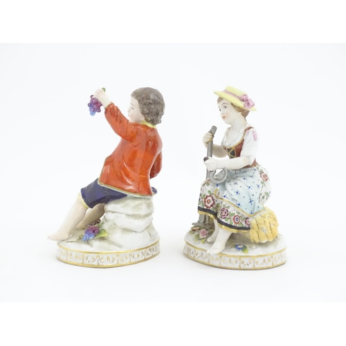 178 - Two Continental Sitzendorf style figures, a boy modelled as a grape picker, and a girl modelled as a... 