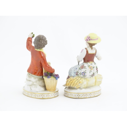 178 - Two Continental Sitzendorf style figures, a boy modelled as a grape picker, and a girl modelled as a... 