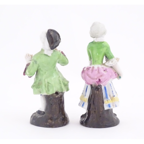 182 - Two Continental ceramic figures, depicting a Regency gentleman and a young lady. One indistinctly ma... 