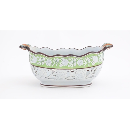 189 - A pearlware style chestnut basket with scrolling pierced decoration and floral and foliate detail. M... 