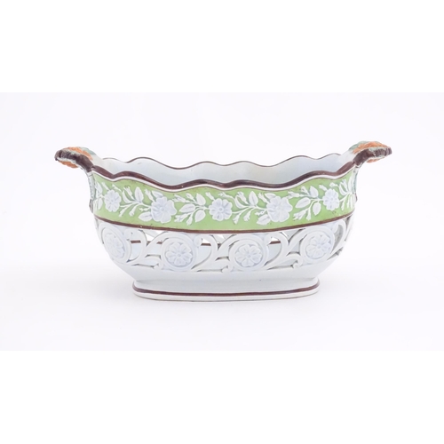 189 - A pearlware style chestnut basket with scrolling pierced decoration and floral and foliate detail. M... 