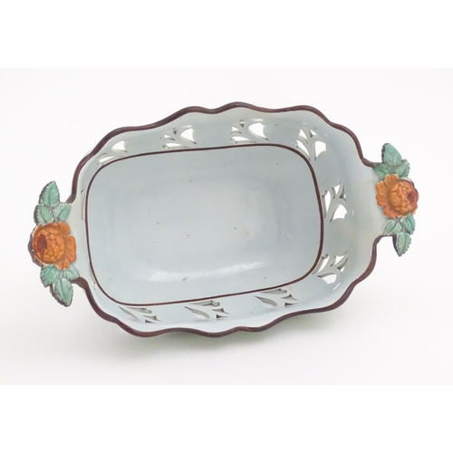 189 - A pearlware style chestnut basket with scrolling pierced decoration and floral and foliate detail. M... 