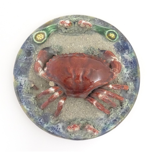 194 - A Palissy style plate with relief crab and shell detail. Approx. 9 3/4