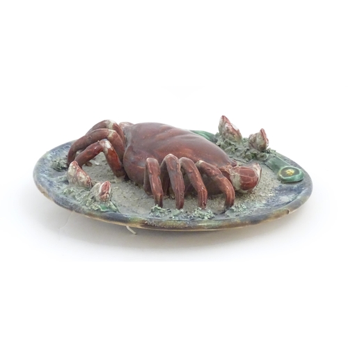 194 - A Palissy style plate with relief crab and shell detail. Approx. 9 3/4