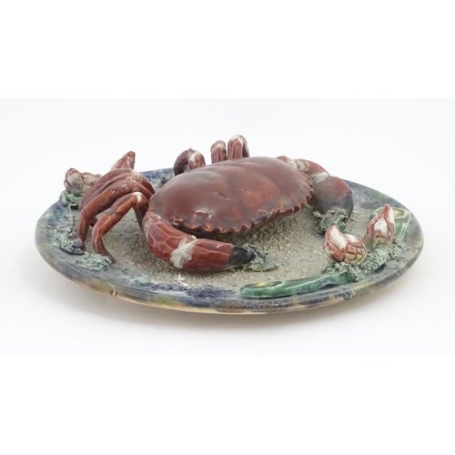 194 - A Palissy style plate with relief crab and shell detail. Approx. 9 3/4