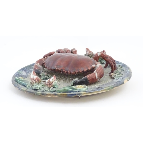 194 - A Palissy style plate with relief crab and shell detail. Approx. 9 3/4