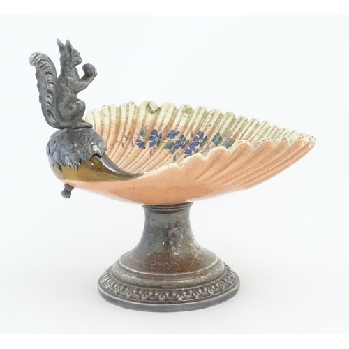 195 - A Sarreguemines tazza / comport of shell form with flower detail, with silver plate foot and a model... 