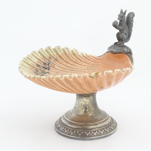 195 - A Sarreguemines tazza / comport of shell form with flower detail, with silver plate foot and a model... 