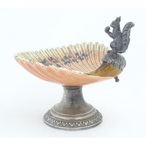 195 - A Sarreguemines tazza / comport of shell form with flower detail, with silver plate foot and a model... 