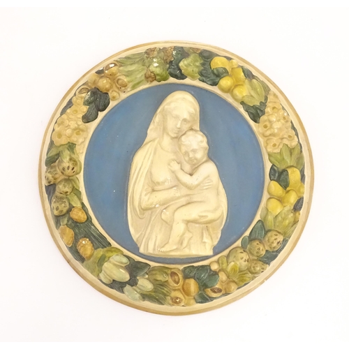 196 - A Della Robbia style plaque depicting Mother & Child in relief, bordered by flower, foliage and frui... 