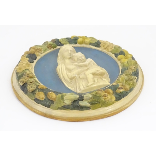 196 - A Della Robbia style plaque depicting Mother & Child in relief, bordered by flower, foliage and frui... 