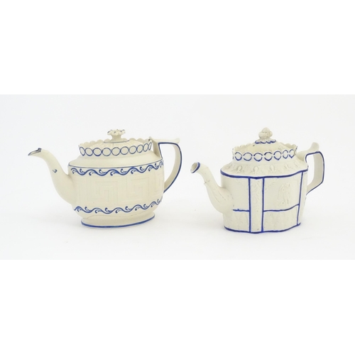 204 - A Castleford Pottery style blue and white teapot with unusual sliding lid, decorated in relief with ... 