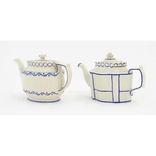 204 - A Castleford Pottery style blue and white teapot with unusual sliding lid, decorated in relief with ... 