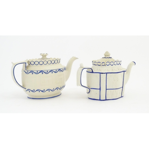 204 - A Castleford Pottery style blue and white teapot with unusual sliding lid, decorated in relief with ... 