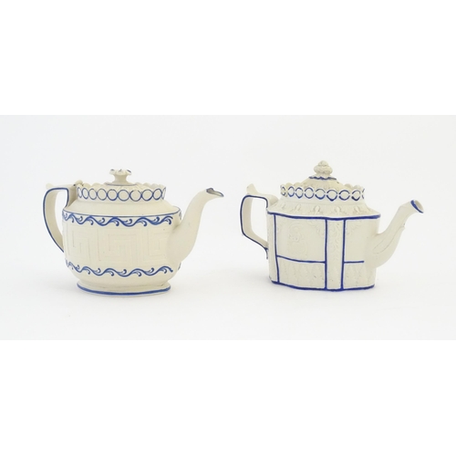 204 - A Castleford Pottery style blue and white teapot with unusual sliding lid, decorated in relief with ... 