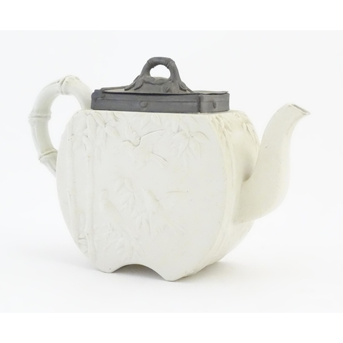 205 - A Victorian Copeland Spode bisque teapot with Aesthetic period decoration depicting birds and bamboo... 