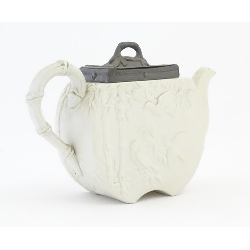 205 - A Victorian Copeland Spode bisque teapot with Aesthetic period decoration depicting birds and bamboo... 