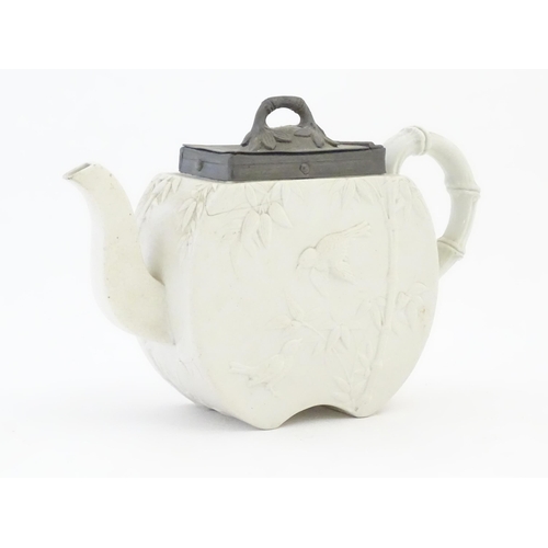 205 - A Victorian Copeland Spode bisque teapot with Aesthetic period decoration depicting birds and bamboo... 