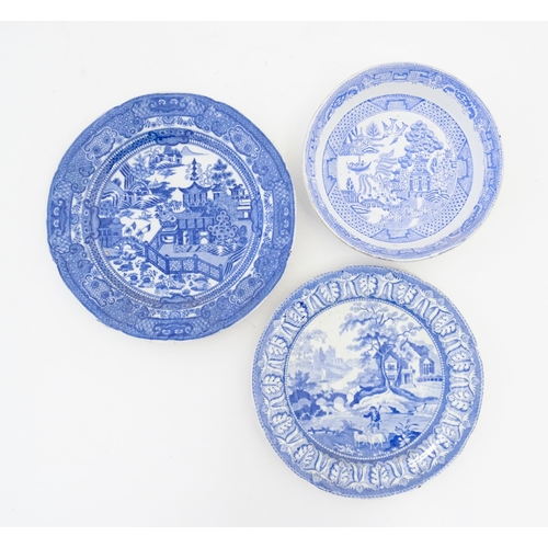 213 - A quantity of assorted blue and white plates, patterns to include Willow, rural scenes, etc. Makers ... 