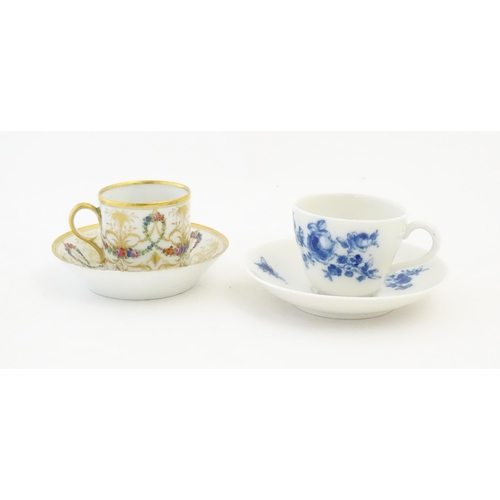 215 - A Meissen blue and white tea cup and saucer in the still life pattern with flowers and insects. Toge... 