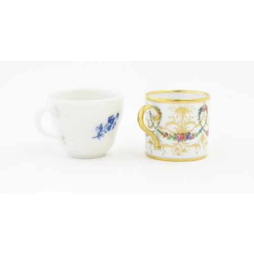 215 - A Meissen blue and white tea cup and saucer in the still life pattern with flowers and insects. Toge... 