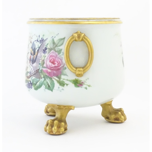 217 - A Continental jardiniere / planter decorated with flowers, foliage, birds and butterlies. With twin ... 