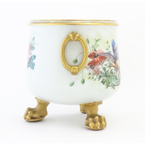 217 - A Continental jardiniere / planter decorated with flowers, foliage, birds and butterlies. With twin ... 