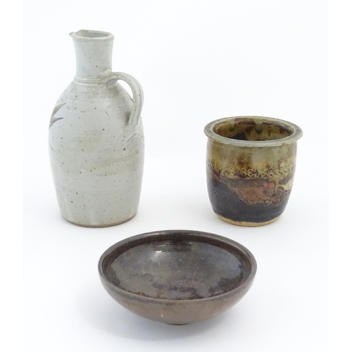 231 - Three items of studio pottery, comprising a jug with loop handle and brushwork decoration, a footed ... 