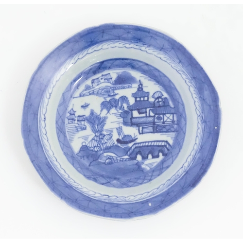 238 - A Chinese blue and white bowl of octagonal form decorated with figures and vases of flowers in bloom... 