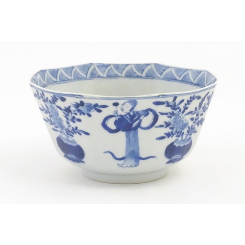 238 - A Chinese blue and white bowl of octagonal form decorated with figures and vases of flowers in bloom... 