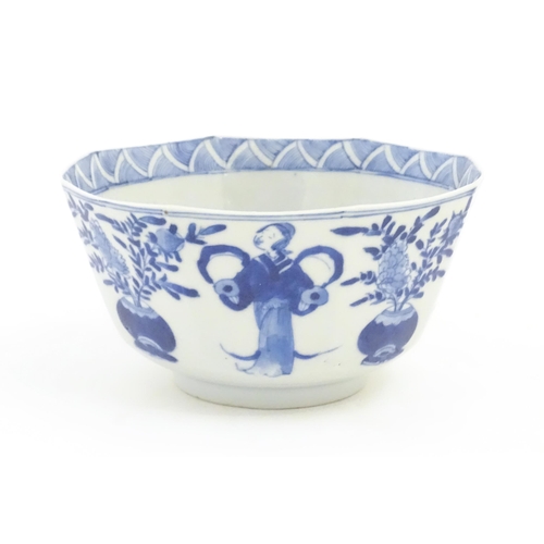 238 - A Chinese blue and white bowl of octagonal form decorated with figures and vases of flowers in bloom... 