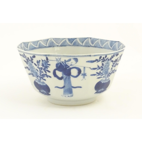 238 - A Chinese blue and white bowl of octagonal form decorated with figures and vases of flowers in bloom... 