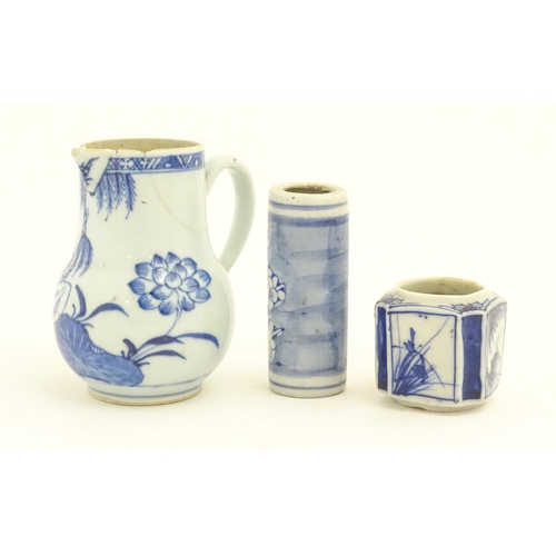 239 - A Chinese blue and white jug decorated with trees, leaves, flowers and foliage. Together with a cyli... 