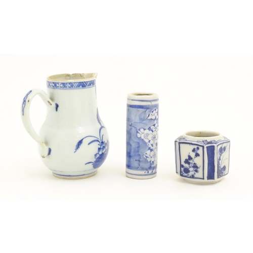 239 - A Chinese blue and white jug decorated with trees, leaves, flowers and foliage. Together with a cyli... 