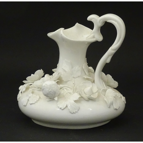 63 - A Derby white glazed jug decorated with encrusted flowers, leaves and strawberries. Marked under. Ap... 