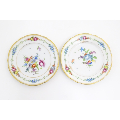 57 - Two Dresden plates decorated with flowers and foliage with gilt rims. Marked under. Approx. 7 3/4