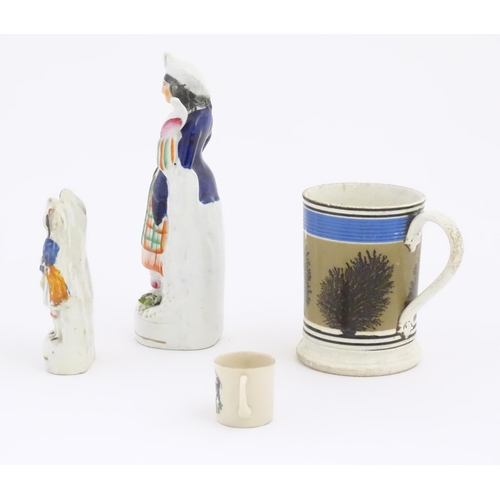 60 - Four assorted ceramic items comprising a mochaware mug with tree detail, a miniature crested ware lo... 