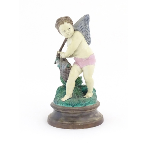 65 - A Continental majolica style putto figure modelled as a fisherman with a net and basket of fish. Mar... 