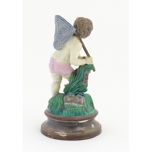 65 - A Continental majolica style putto figure modelled as a fisherman with a net and basket of fish. Mar... 