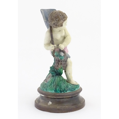 65 - A Continental majolica style putto figure modelled as a fisherman with a net and basket of fish. Mar... 