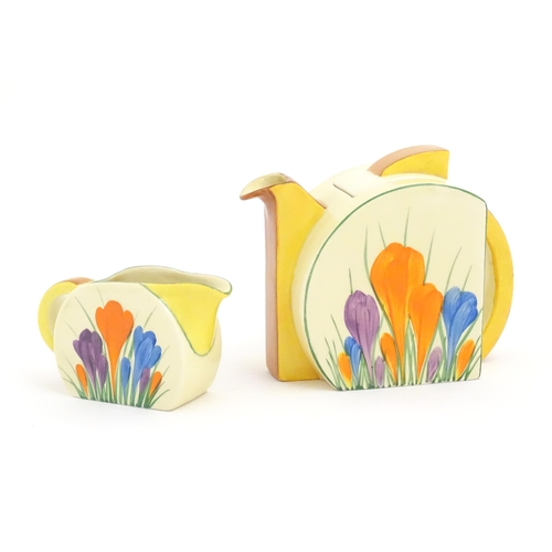 72 - A Clarice Cliff teapot and milk jug decorated in the Crocus pattern. Marked under Bizarre by Clarice... 