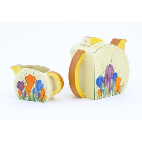 72 - A Clarice Cliff teapot and milk jug decorated in the Crocus pattern. Marked under Bizarre by Clarice... 