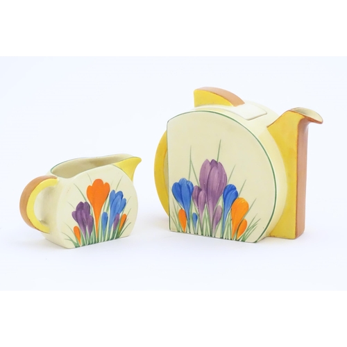 72 - A Clarice Cliff teapot and milk jug decorated in the Crocus pattern. Marked under Bizarre by Clarice... 