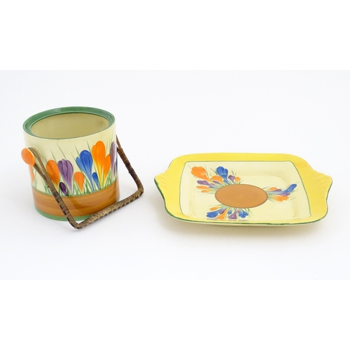 74 - A Clarice Cliff sandwich plate decorated in the Crocus pattern. Together with a Clarice Cliff biscui... 