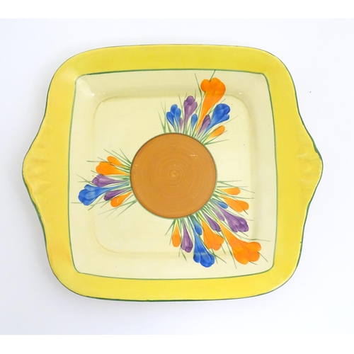 74 - A Clarice Cliff sandwich plate decorated in the Crocus pattern. Together with a Clarice Cliff biscui... 