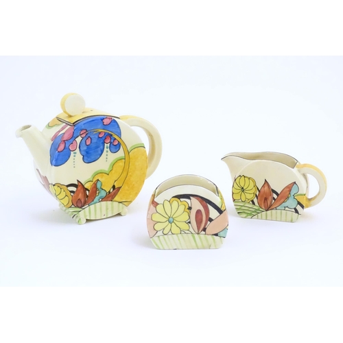 77 - A Clarice Cliff tea set decorated in the Moonlight pattern comprising teapot, sugar bowl and milk ju... 